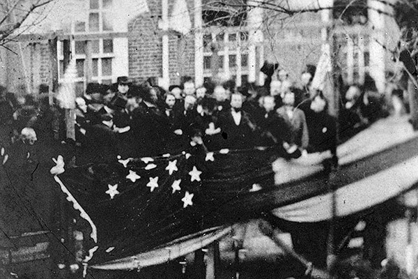 President Lincoln, en route to Washington for his inauguration, raises a flag in Philadelphia to honor the new state of Kansas. Photograph courtesy of the Library of Congress.
