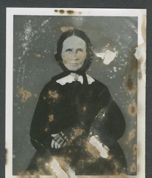 Portrait of an older woman in dress and bonnet