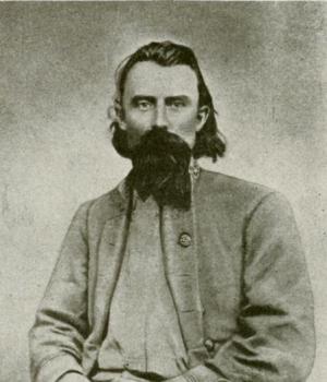 Black and white portrait of Joseph Orville Shelby seated with open coat.
