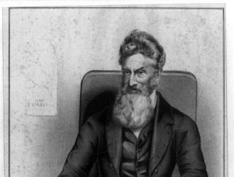A three-quarter length portrait of John Brown facing left and holding the New York Tribune
